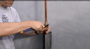 man-installing-an-automatic-shutoff-valve-for-water